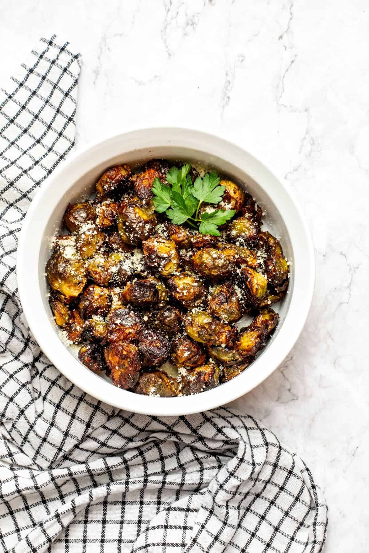 cooked frozen brussel sprouts on a white bowl