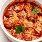 Frozen Meatballs with marinara sauce topped with parsley and cheese