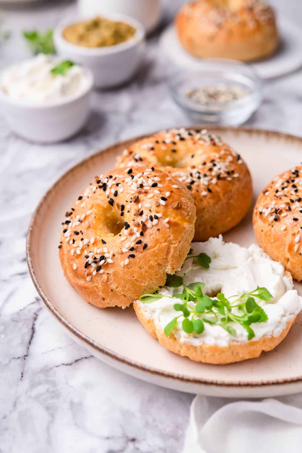 keto bagels on a ceramic plate topped with everything bagel seasoning.