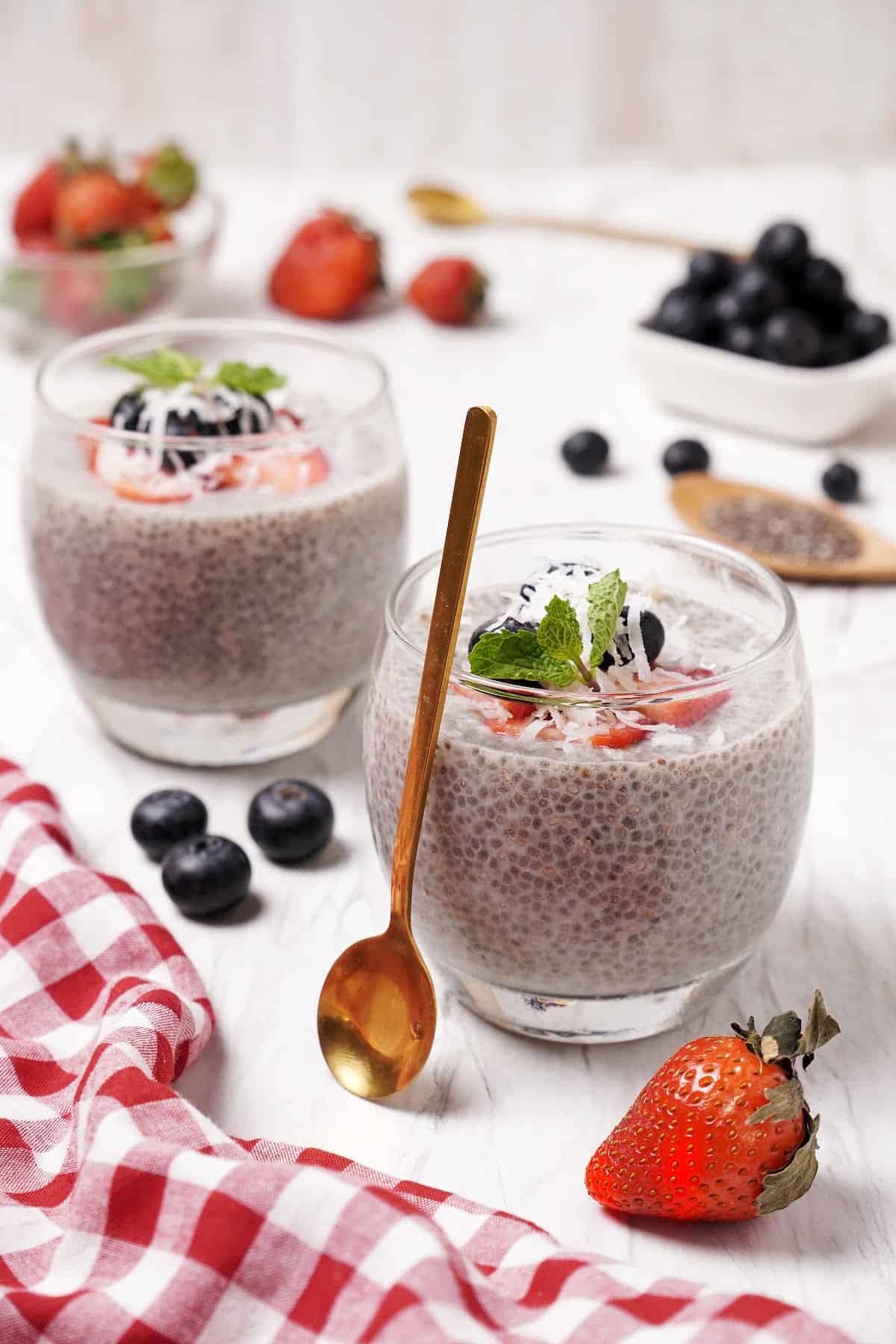 two cups filled with Keto Chia Seed Pudding topped with berries