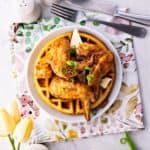 Keto Chicken and Waffles on a plate beside spoon and fork