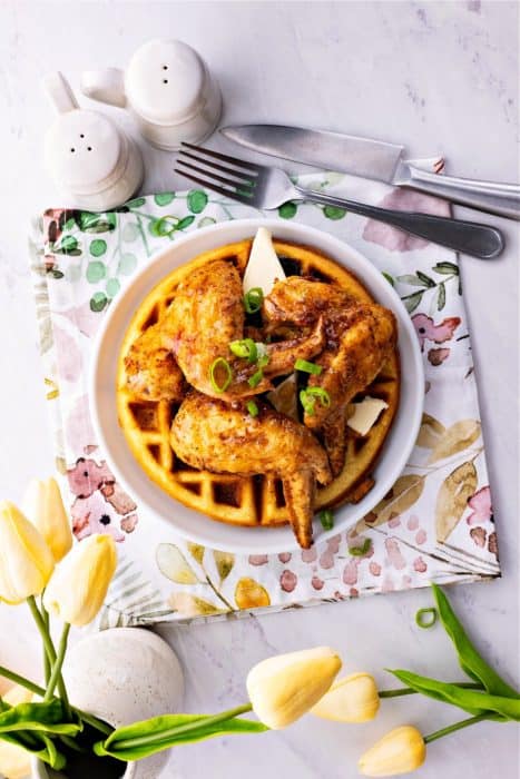 Keto Chicken and Waffles on a plate beside spoon and fork