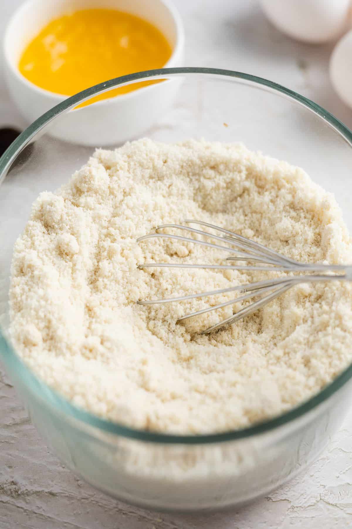 whisking flour on a bowl