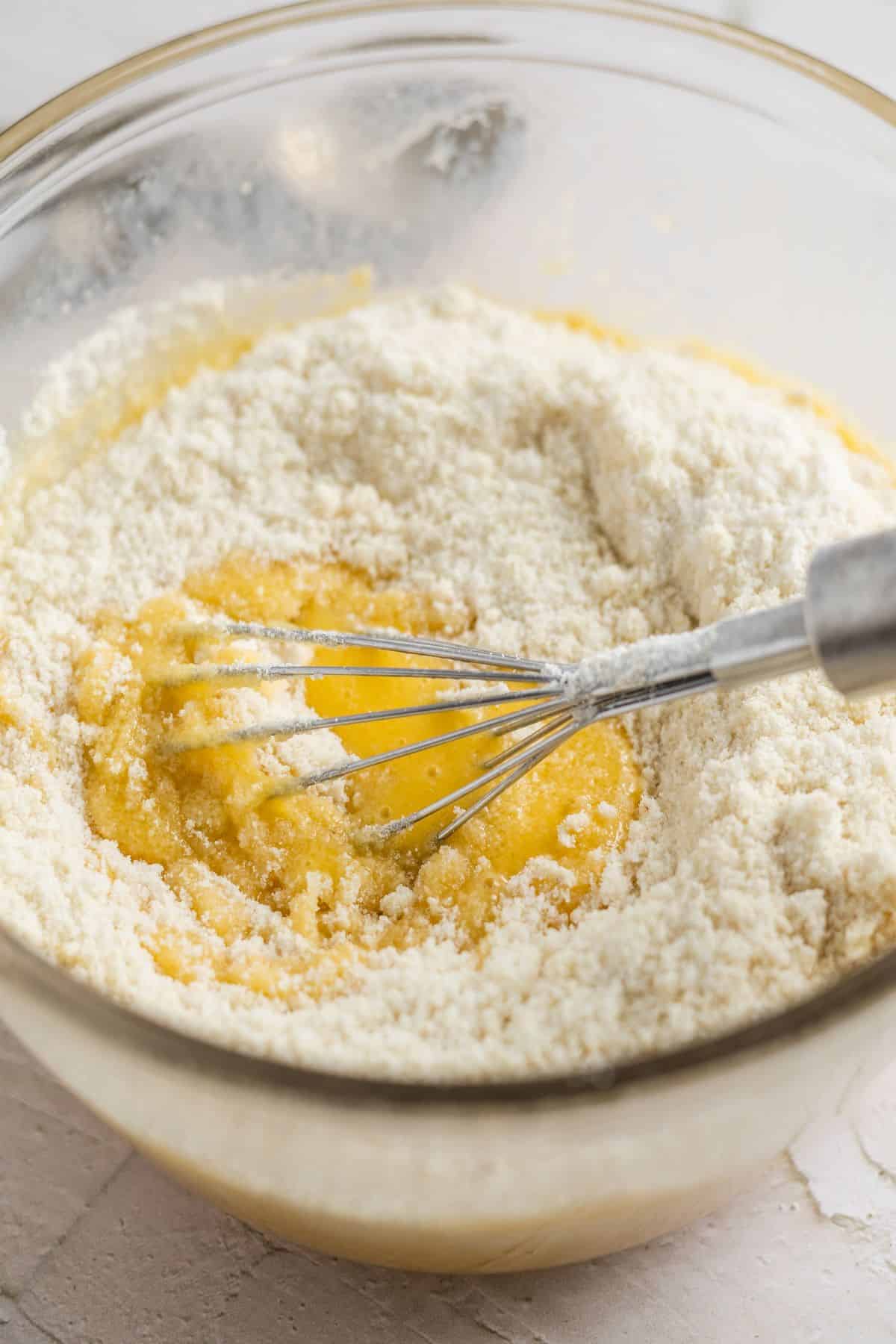 mixing egg and flour using a whisk