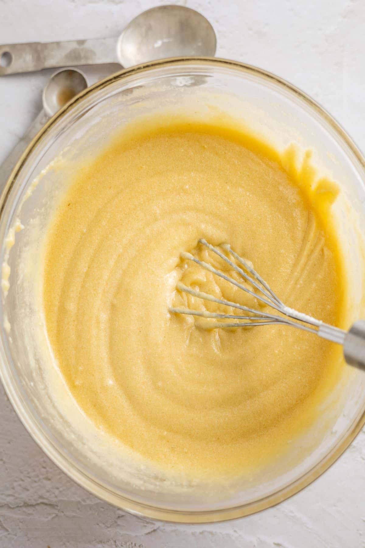 slowly whisking egg and flour on a bowl