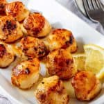 Seared Scallops with lemon on a plate