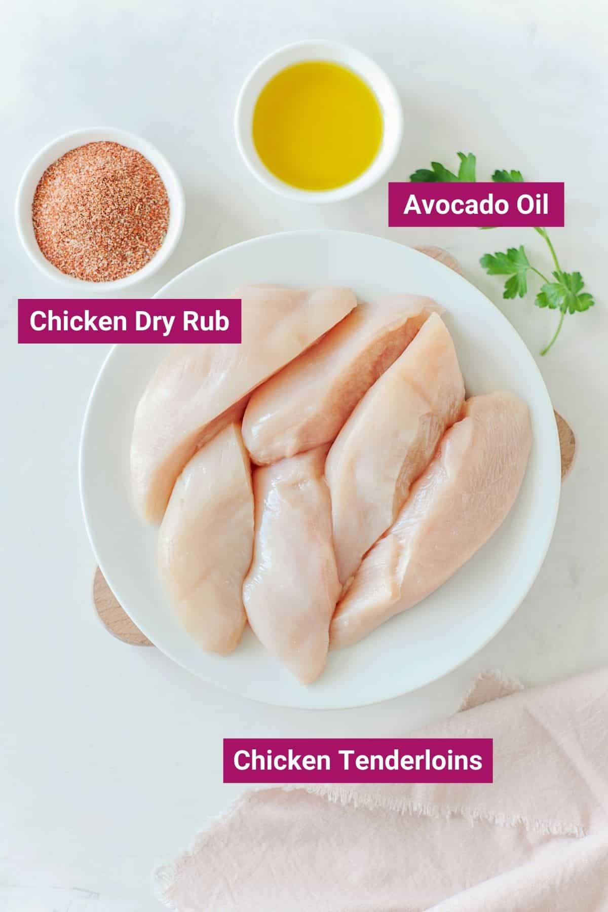 ingredients needed to make air fryer chicken tenderloins: avocado oil and chicken dry rub on small bowls and chicken tenderloins on a large plate