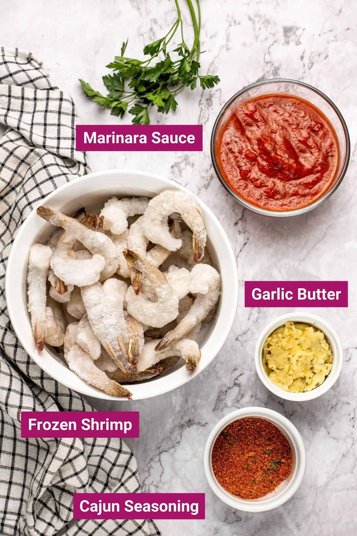 frozen shrimp, marinara sauce, garlic butter and cajun seasoning in separate bowls