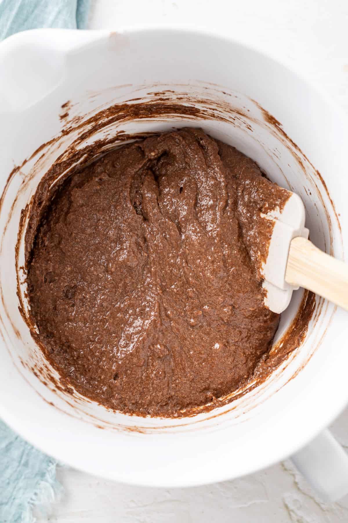 mixing wet and dry ingredients to make brownies