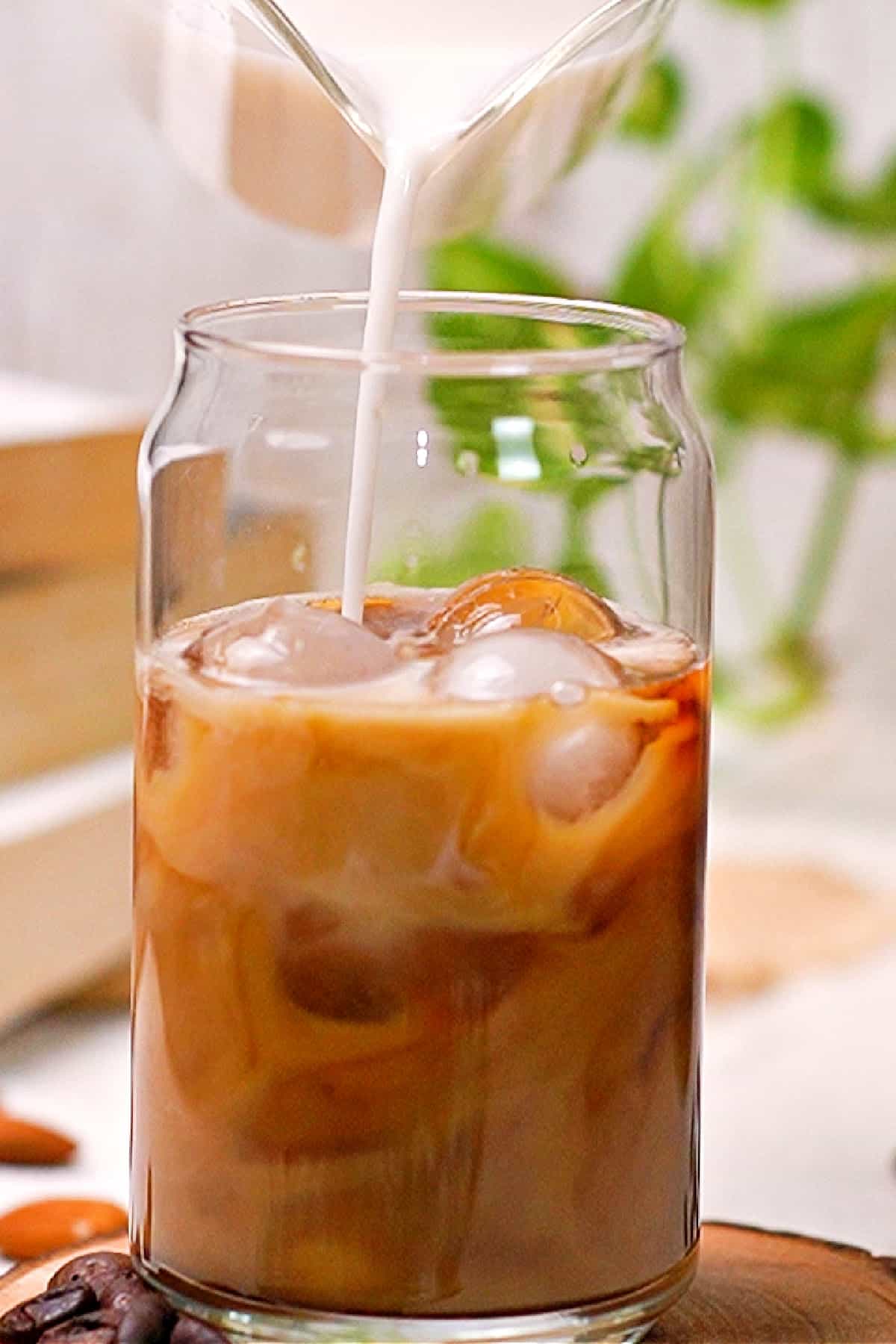 pouring milk into cold brew to make a cold brew latte