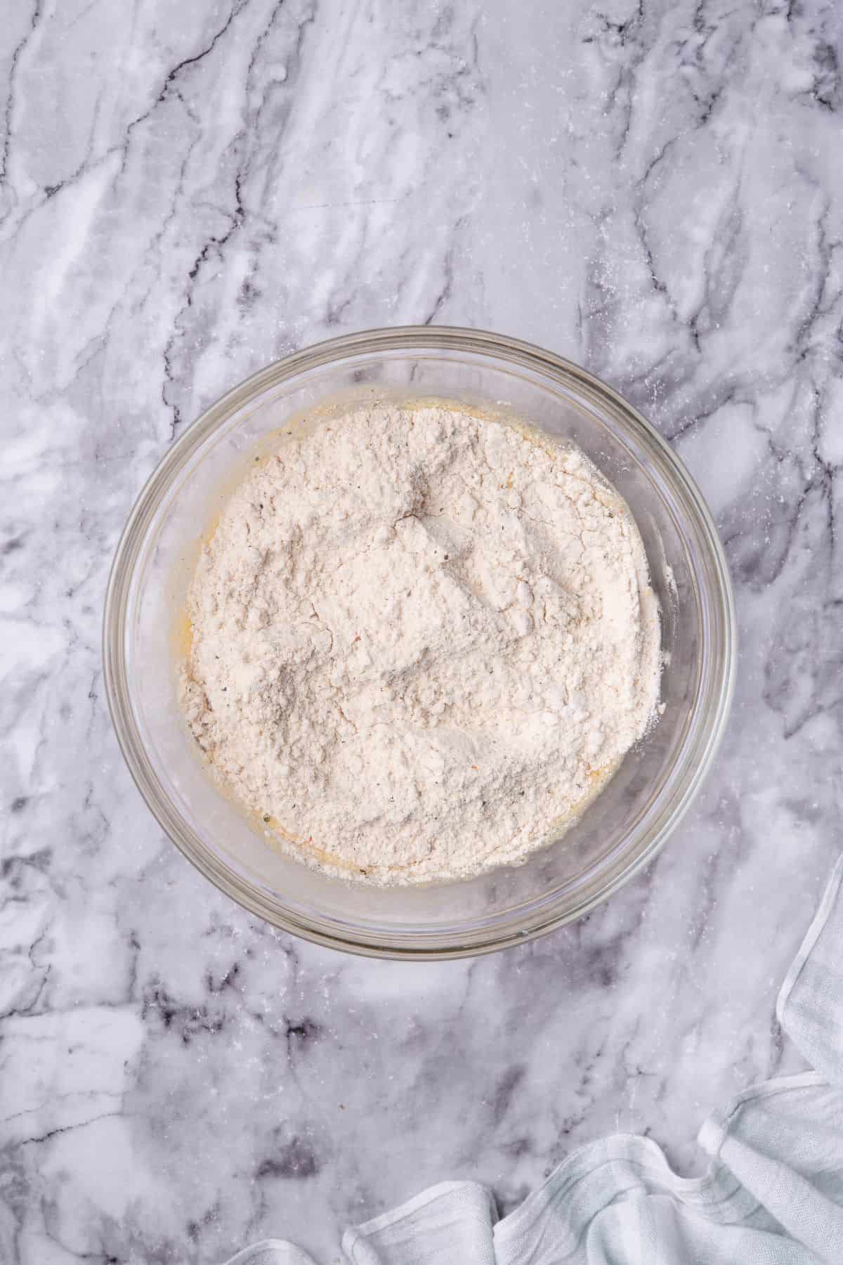 melted parmesan cheese and flour on a mixing bowl
