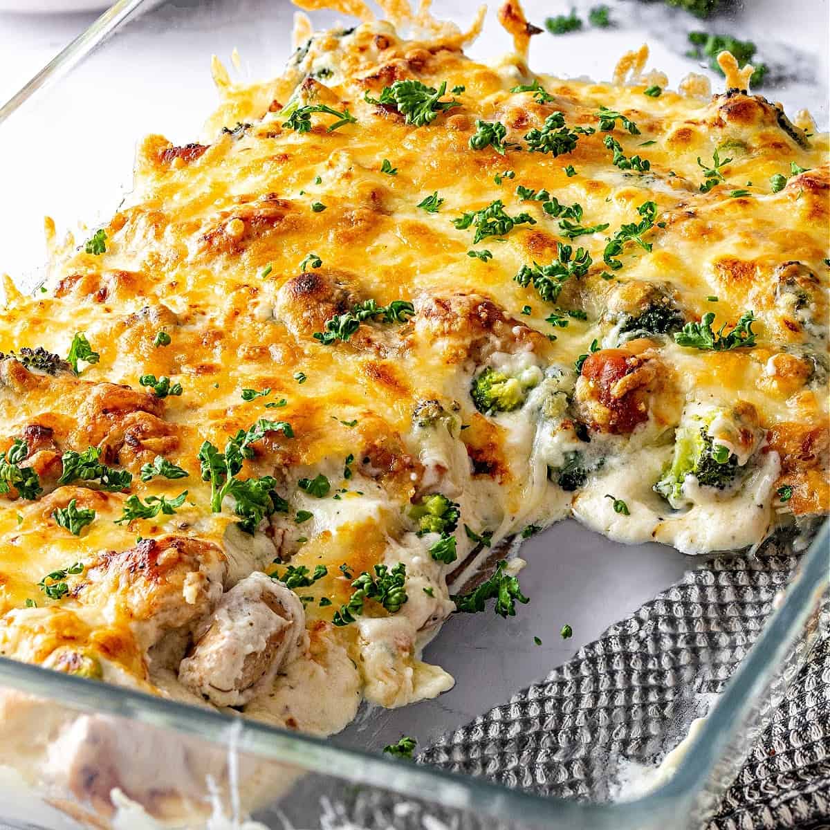 keto chicken alfredo bake in a baking dish with broccoli