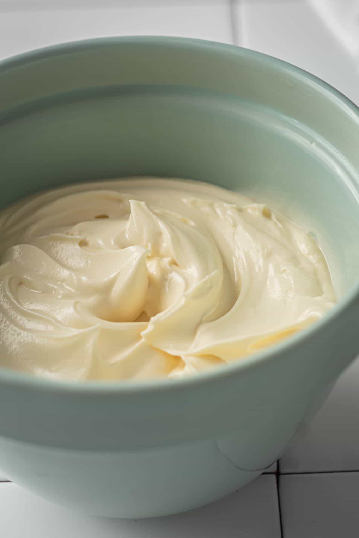 close up shot of Keto Cream Cheese Frosting on a bowl