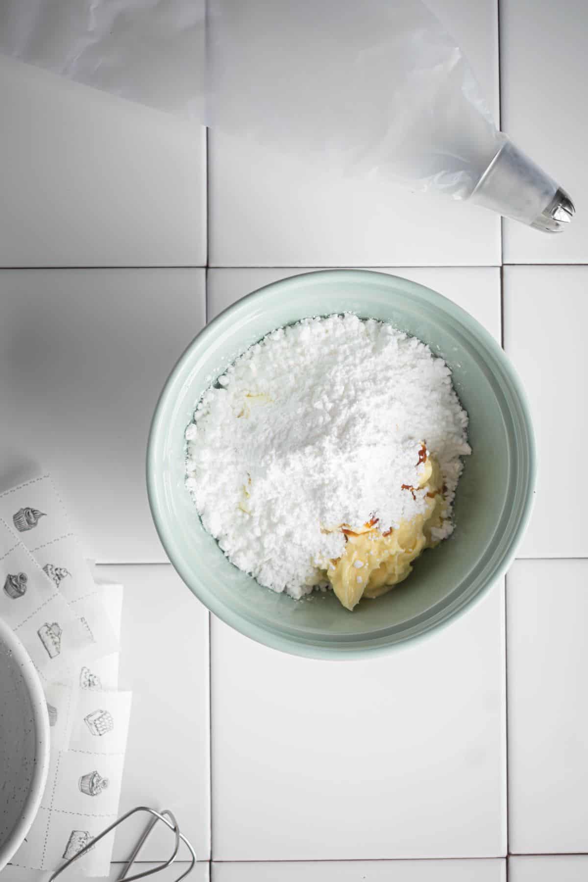 cream cheese, butter and sugar on a ceramic bowl