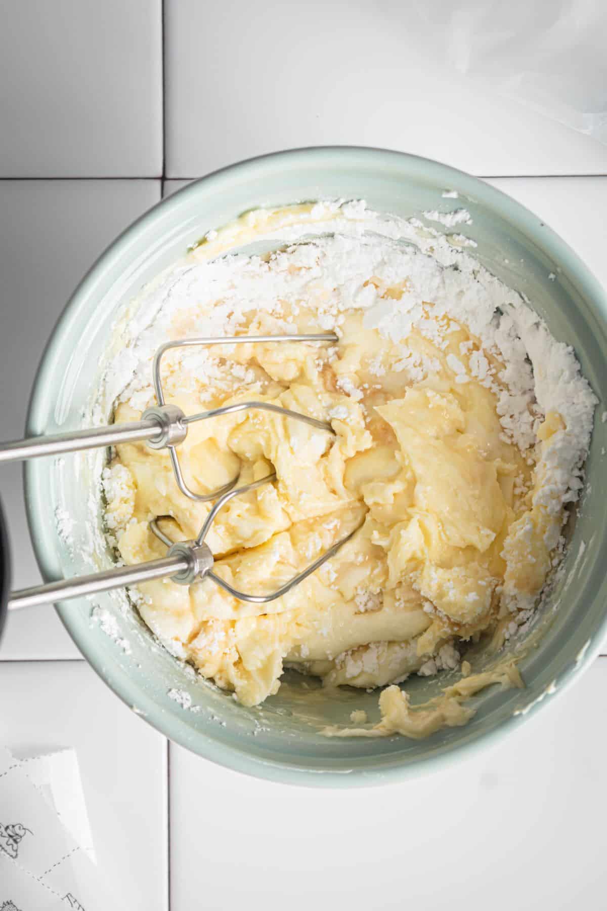 mixing cream cheese and butter using a hand mixer