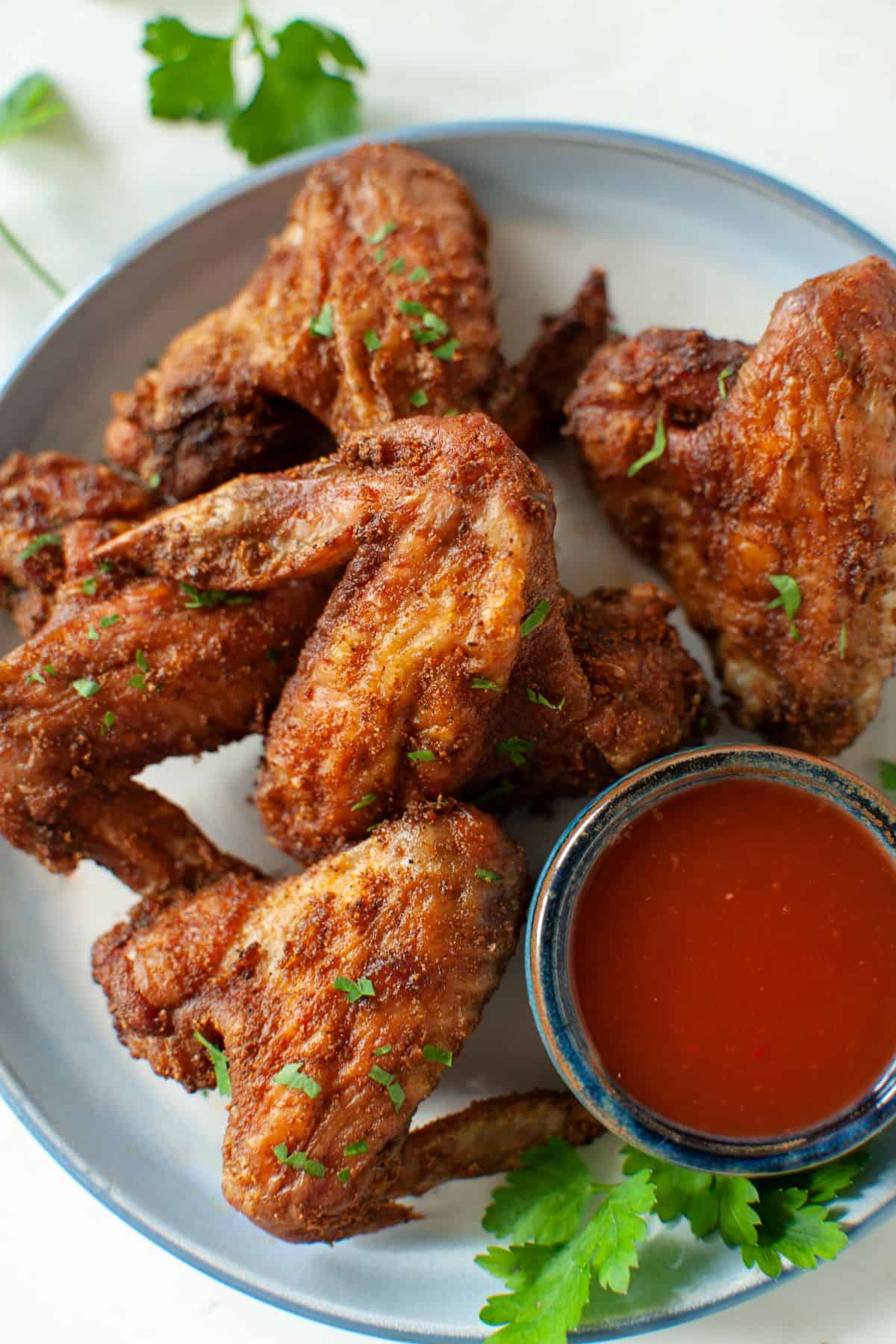Air Fryer Fried Wings and sauce on a plate