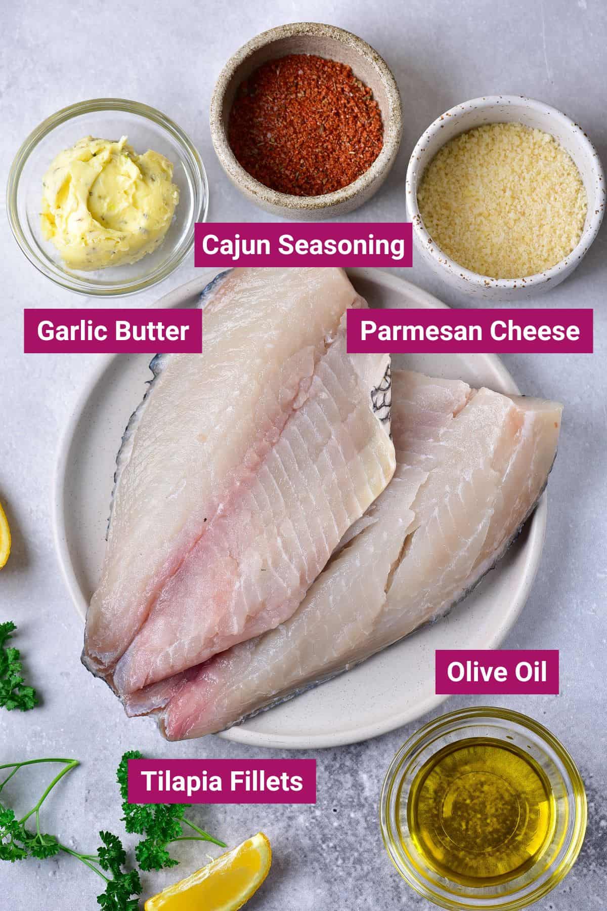 ingredients needed to air fry tilapia: cajun seasoning, garlic butter, parmesan cheese, olive oil and tilapia fillets in separate bowls