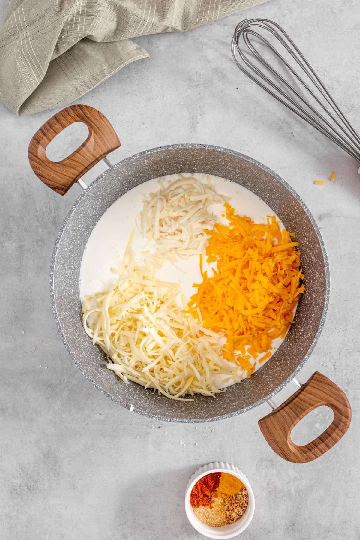 cream cheese, cheddar cheese, gruyere and gouda cheese in a pan