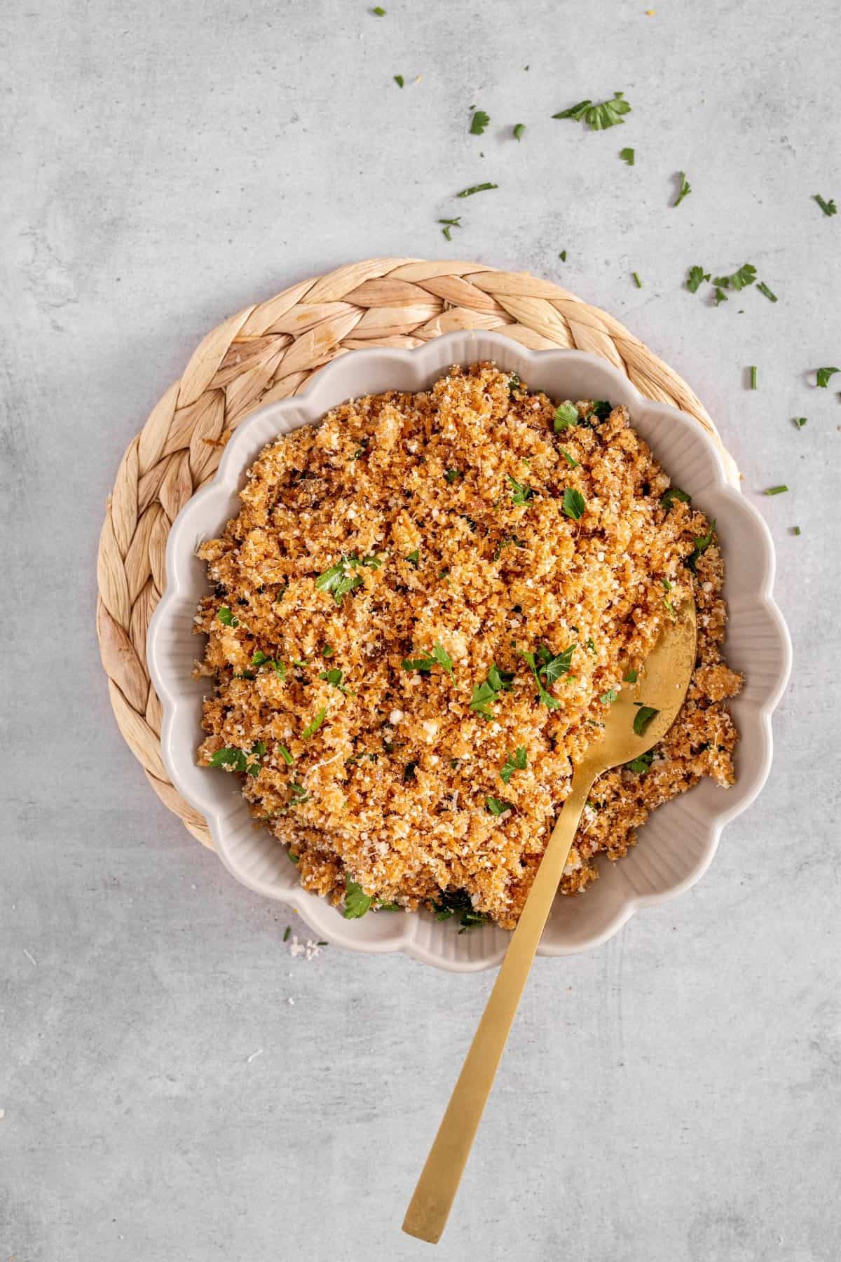 mixing the optional crunchy topping for cauliflower Mac and cheese in a small bowl