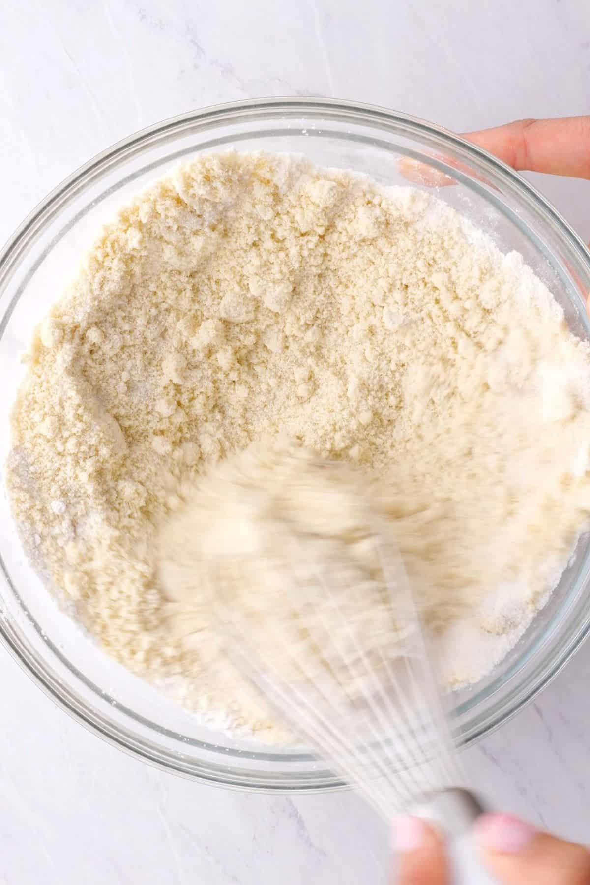 mixing muffin dry ingredients on a large bowl