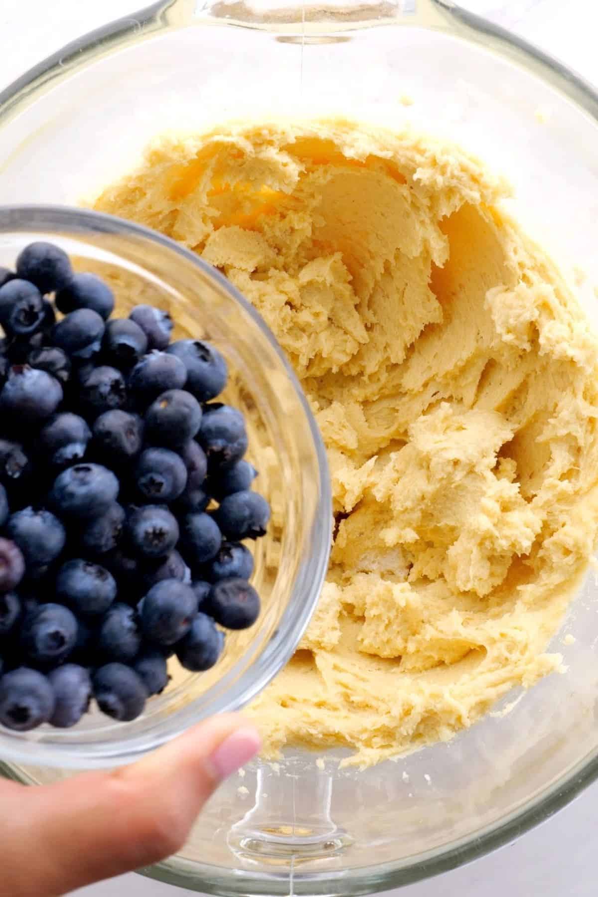 adding blueberries to the muffin batter