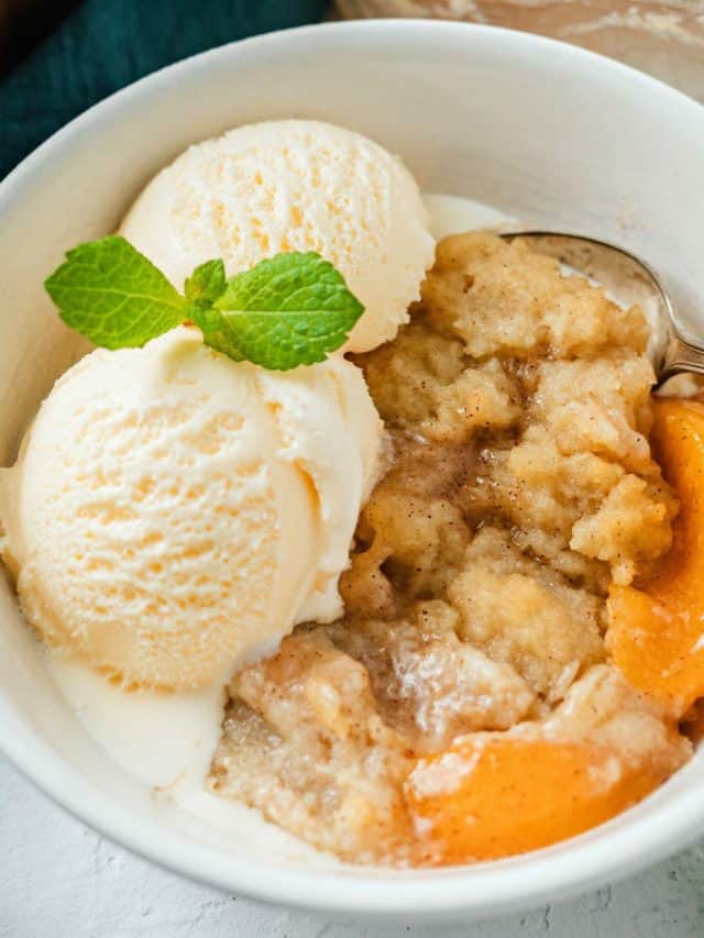 close up shot of Peach Cobbler with vanilla ice cream