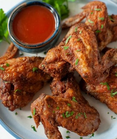 crispy air fryer whole chicken wings and sauce on a plate