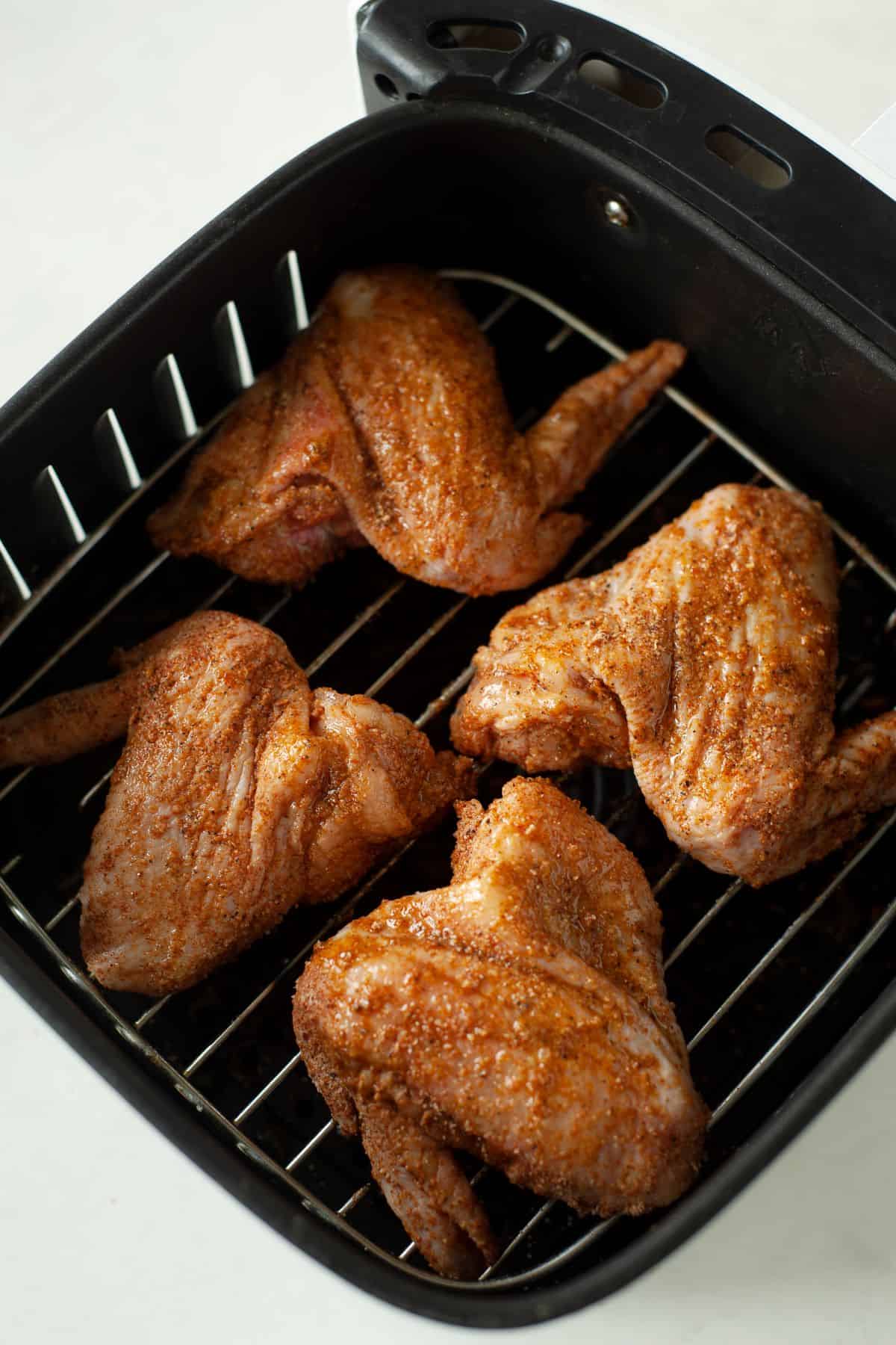 seasoned chicken wings in an air fryer