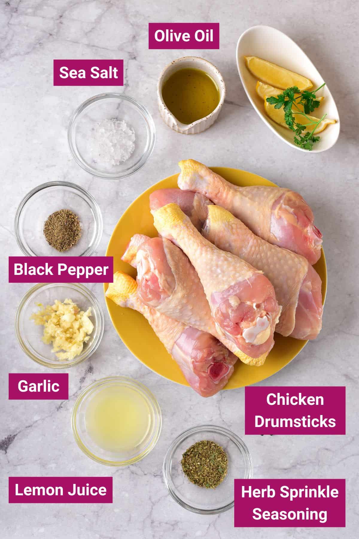 salt, black pepper, olive oil, garlic, lemon juice, chicken drumsticks and herb seasoning on separate bowls