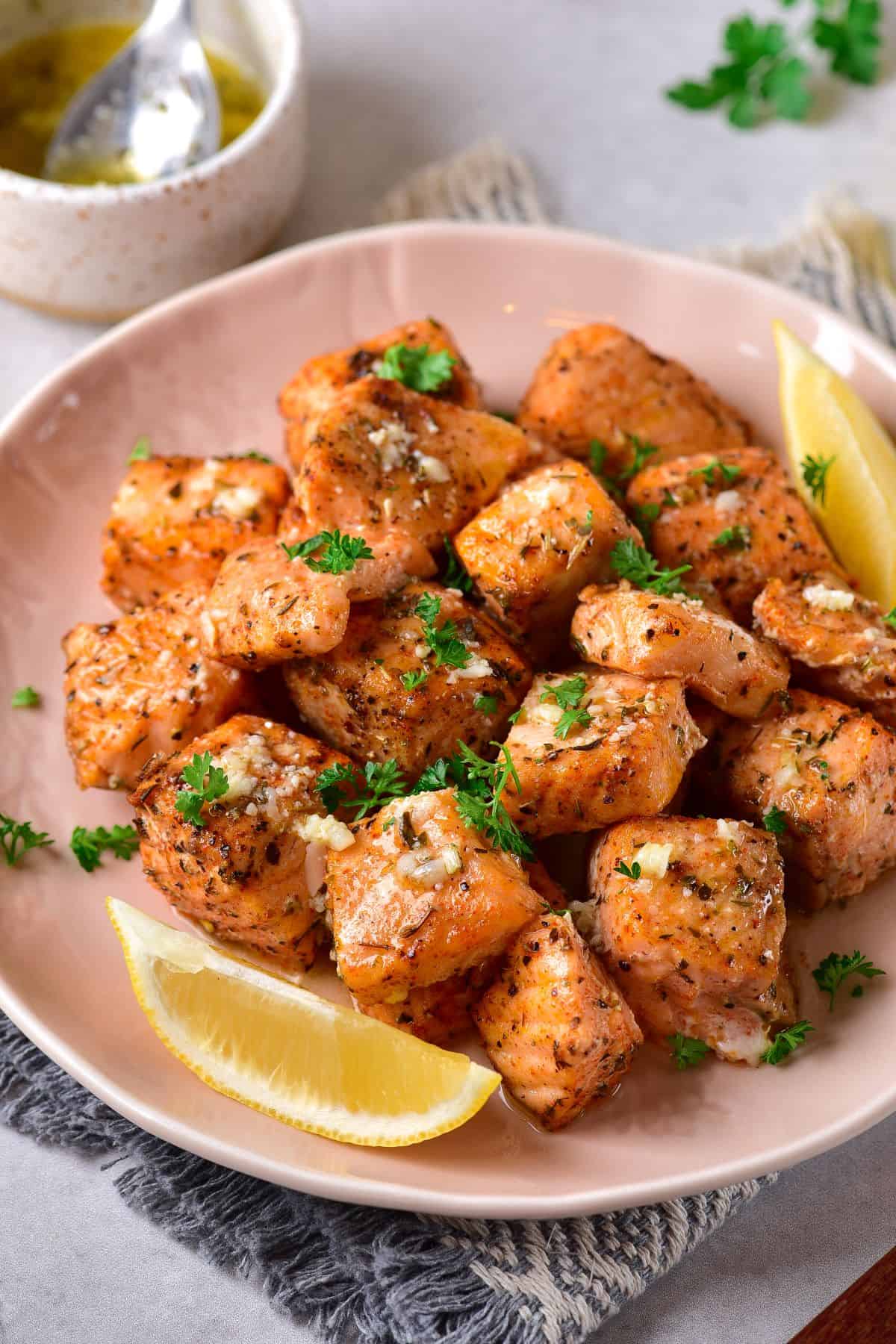 Air Fryer Salmon Bites with slices of lemon on the side