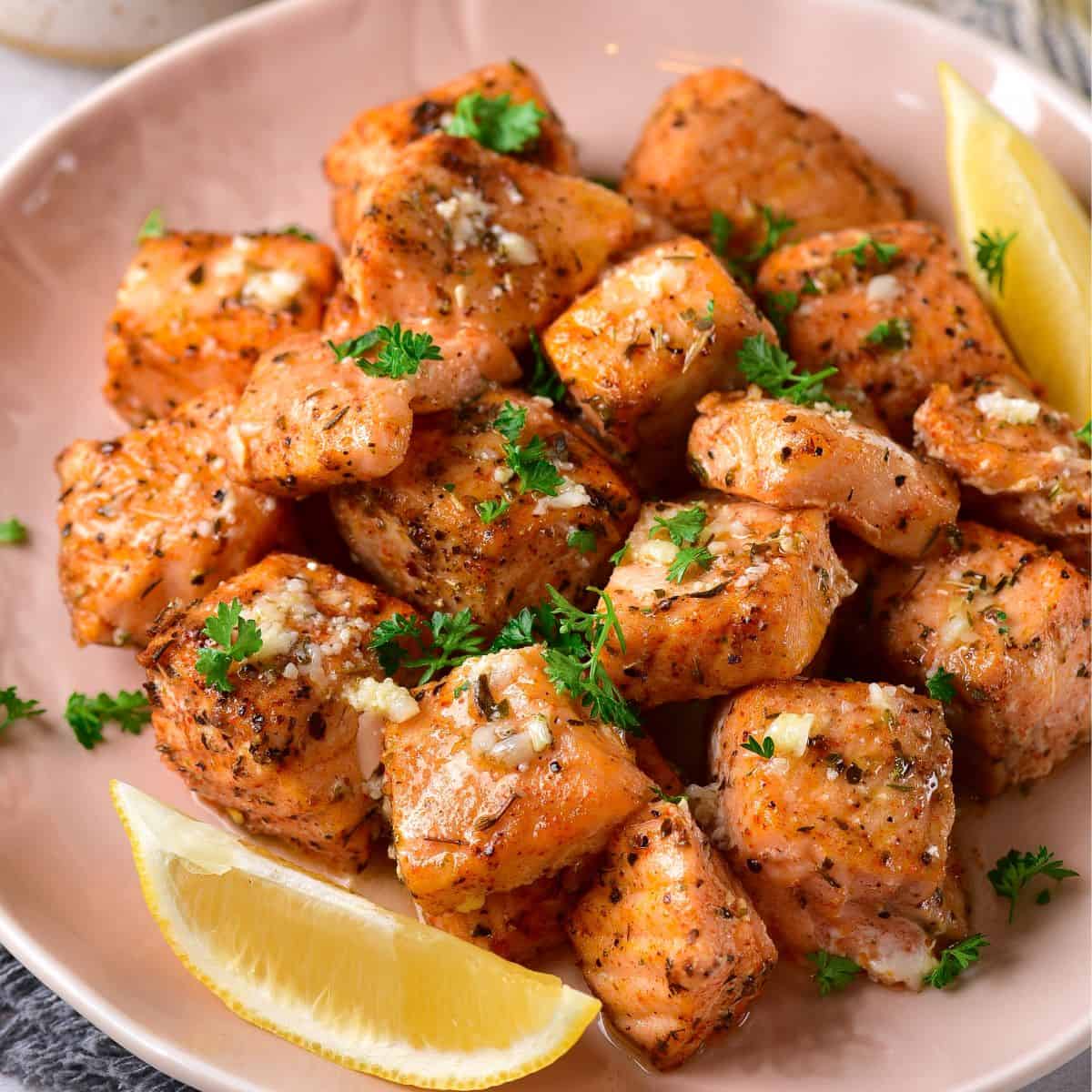 Salmon Bites with slices of lemon on the side