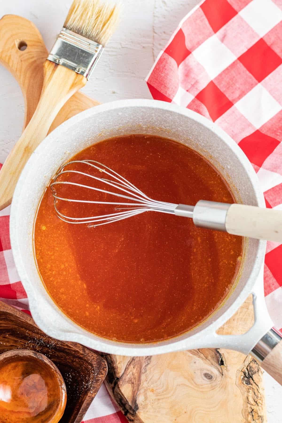 mixing bbq sauce on a round pan