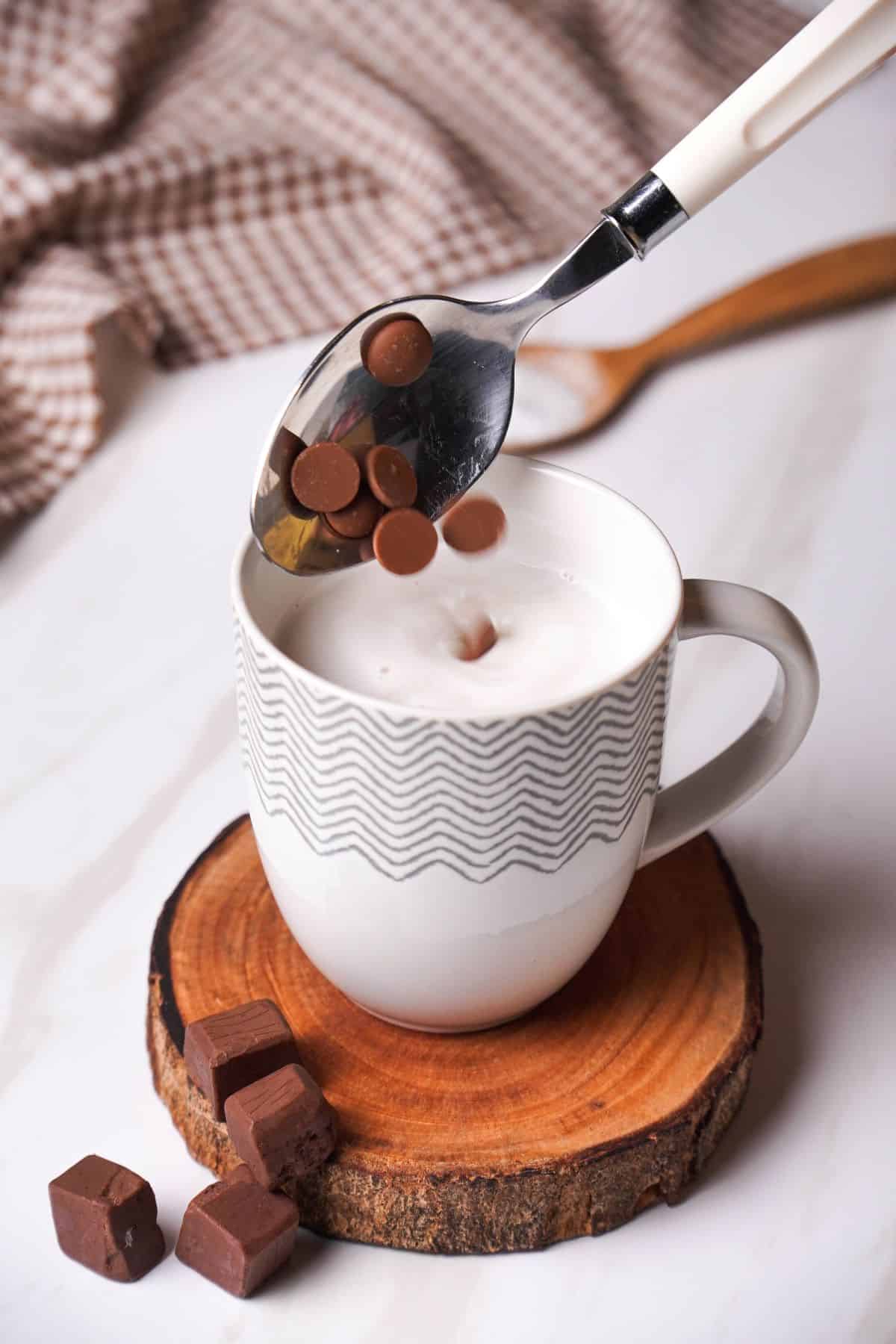 adding sugar-free chocolate chips to the warmed milk.