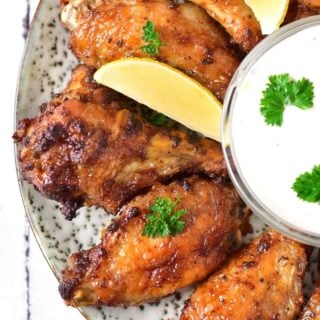 yummy ranch wings with slices of lemon on a plate