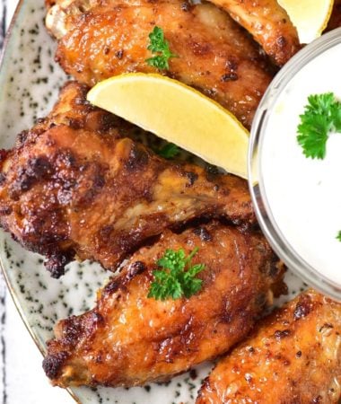 yummy ranch wings with slices of lemon on a plate