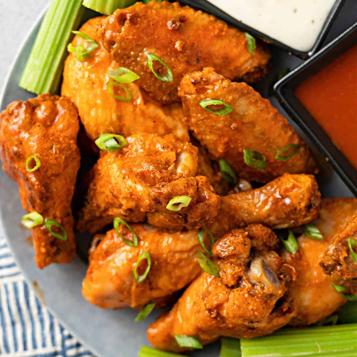 Baked Buffalo Wings with celery on a plate