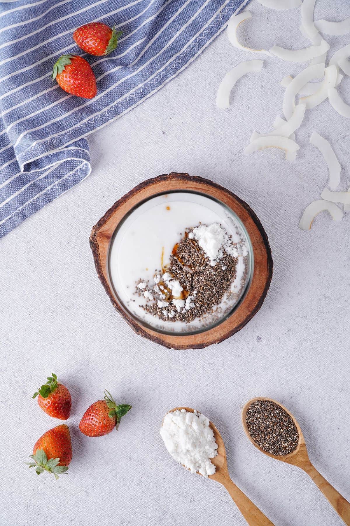 black chia seeds, powdered sugar, coconut milk and vanilla extract on a jar