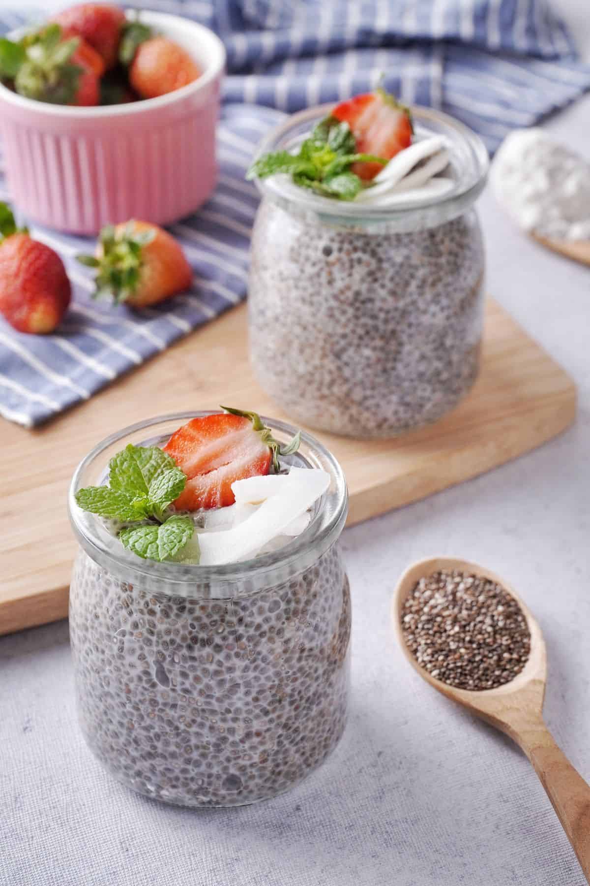Chia Seed Pudding With Coconut Milk on a clear mug beside a spoon full of chia seeds