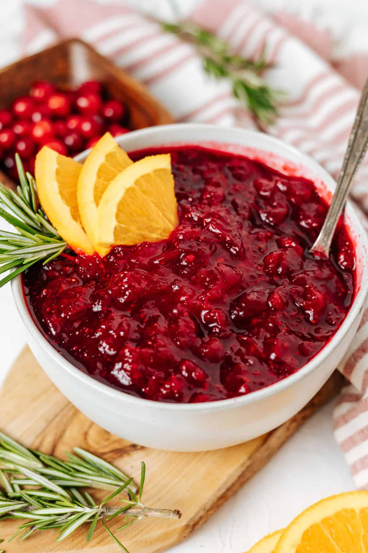Keto Cranberry Sauce topped with slices of oranges on a bowl