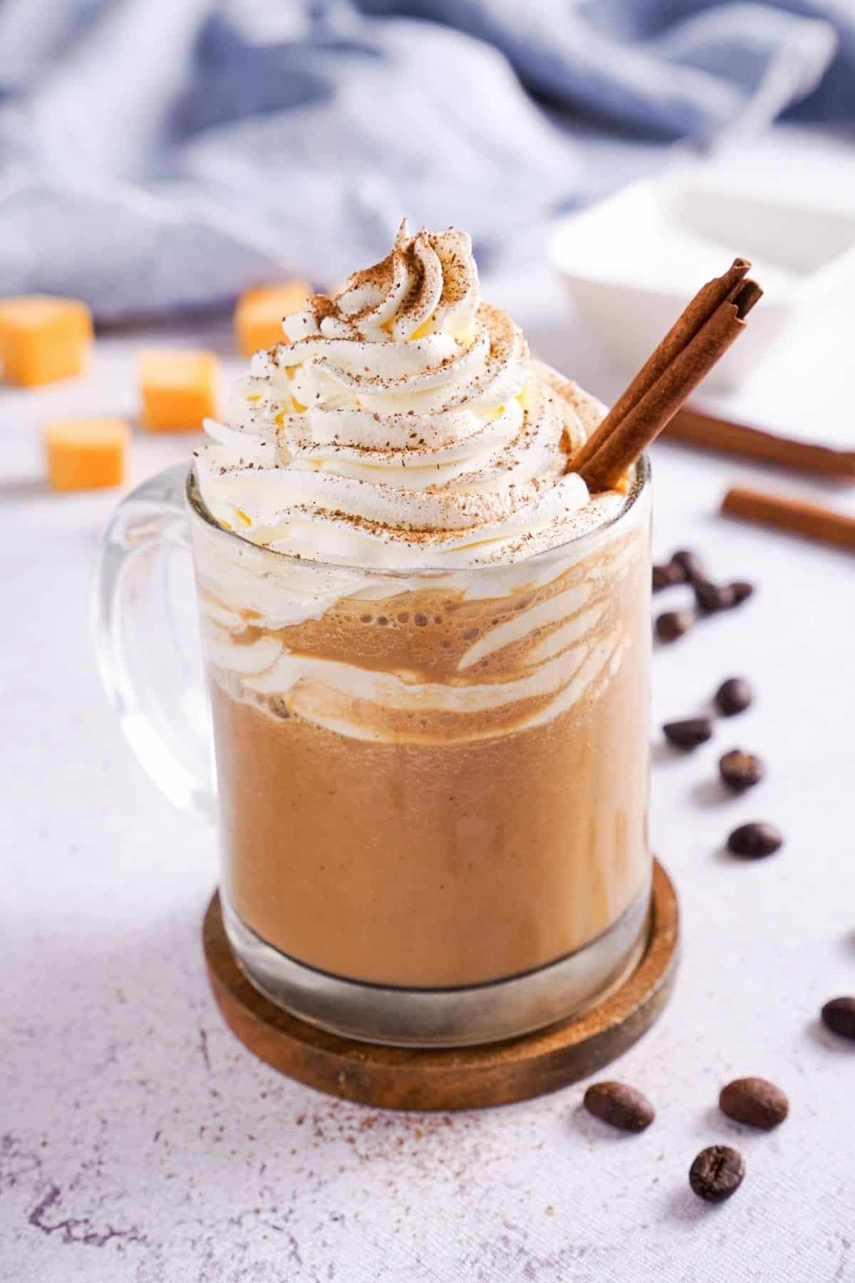 Keto Pumpkin Spice Latte topped with whipped cream and cinnamon sticks