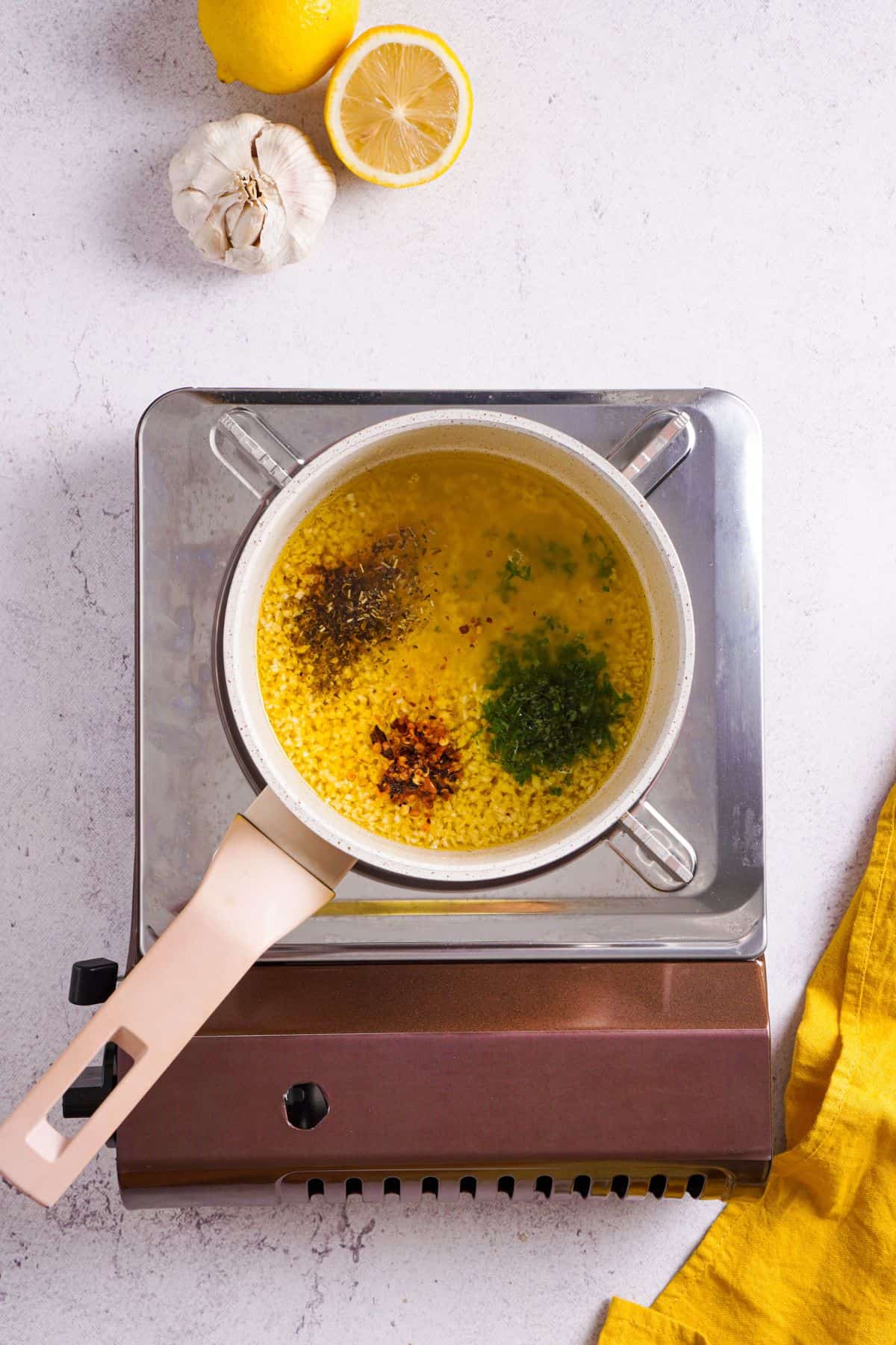 adding parsley, red pepper flakes and herb seasoning on a pan with lemon butter