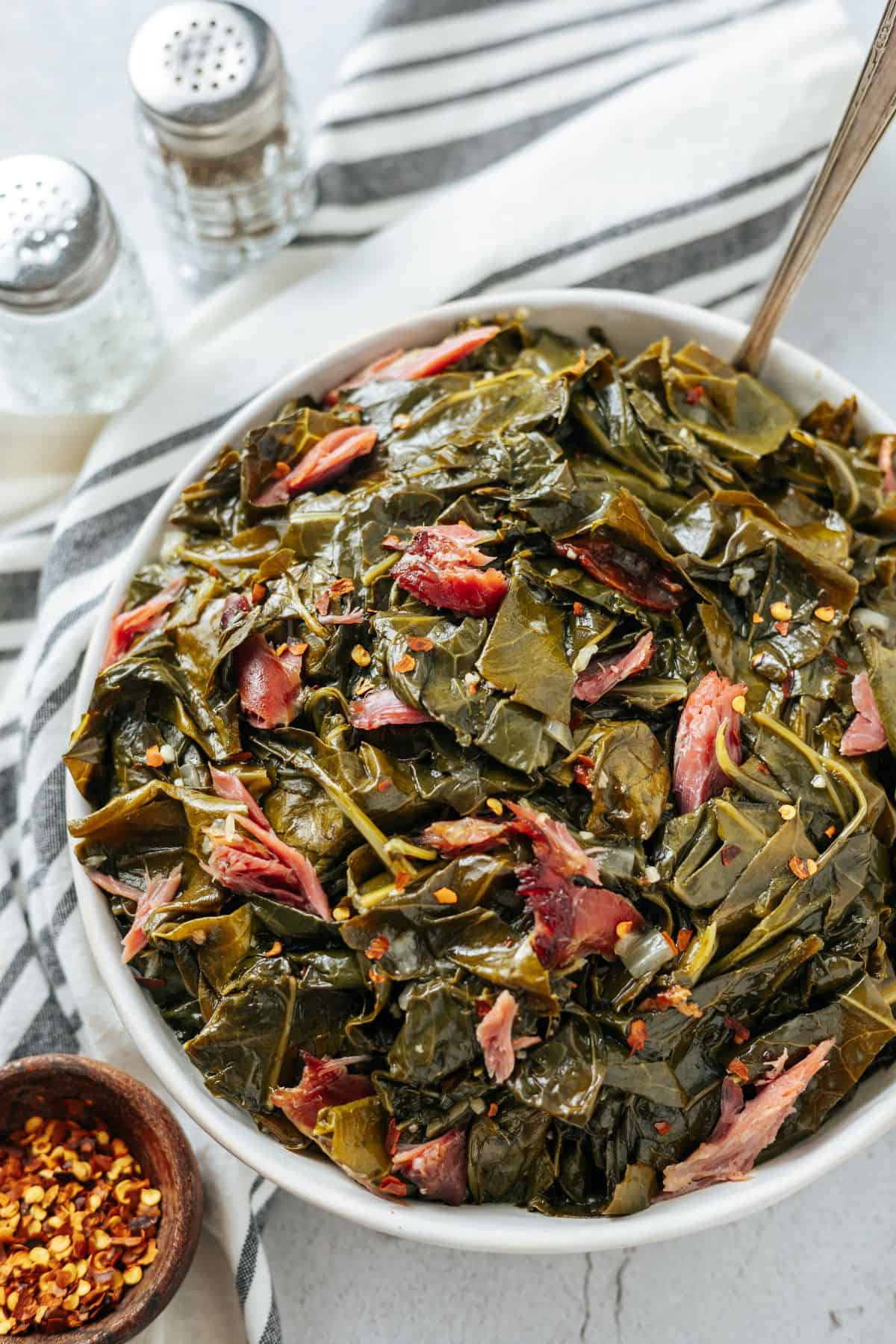 pressure cooker instant pot Collard Greens topped with red pepper flakes on a large bowl