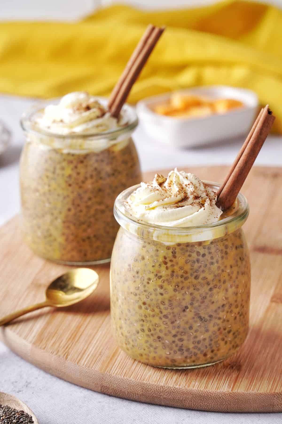 two keto Pumpkin Chia Seed Pudding servings in small, glass jars