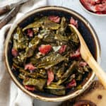 slow cooker crockpot collard greens with ham hocks in a bowl