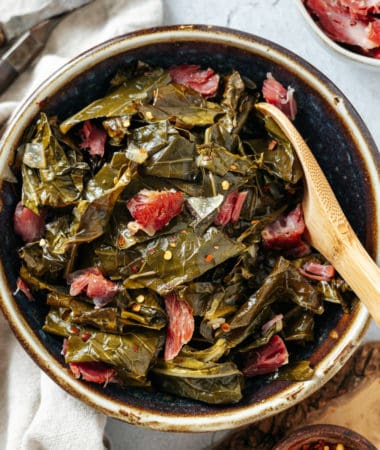 slow cooker crockpot collard greens with ham hocks in a bowl