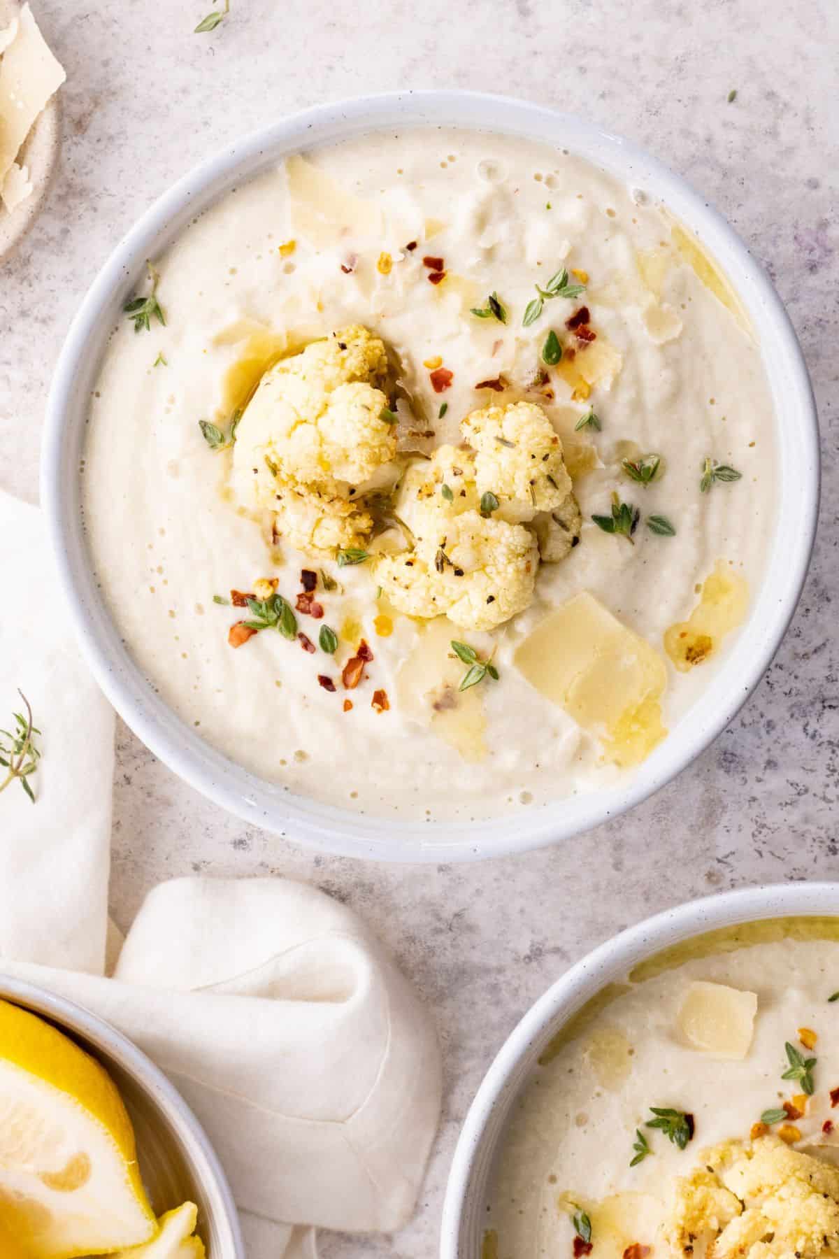 creamy Roasted Cauliflower Soup on a large white bowl