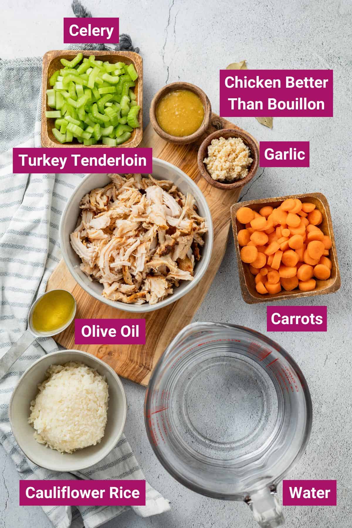 ingredients needed to make leftover turkey soup: celery, turkey tenderloin, chicken better than bouillon, garlic, carrots, olive oil, cauliflower rice and water on separate bowls and containers