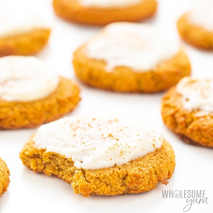 keto pumpkin cookies with frosting on a baking sheet