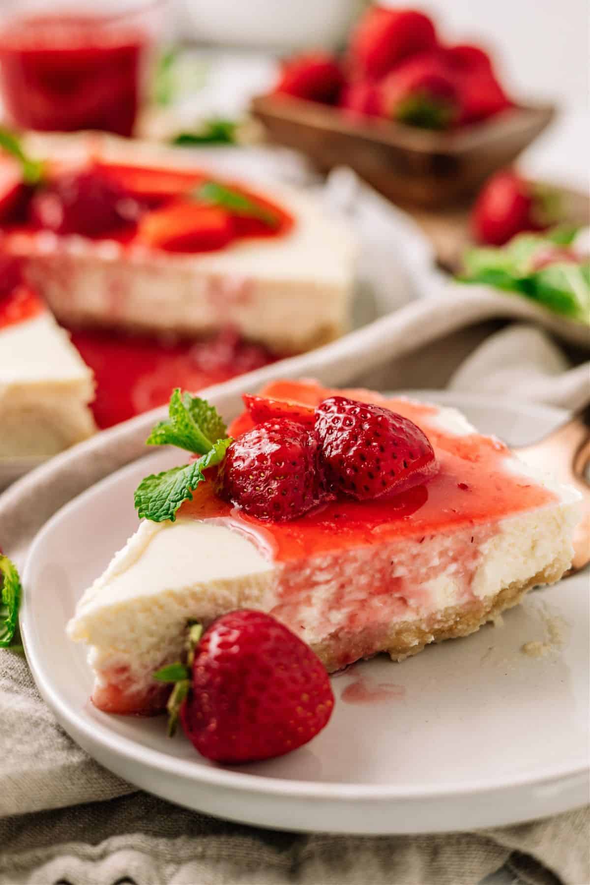 Keto Strawberry Cheesecake topped with strawberries on a plate