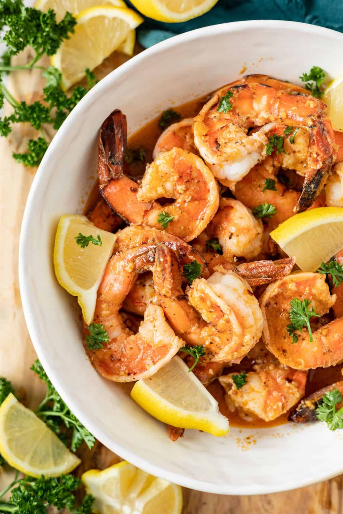 delicious old bay shrimp on a large bowl topped with slices of lemon